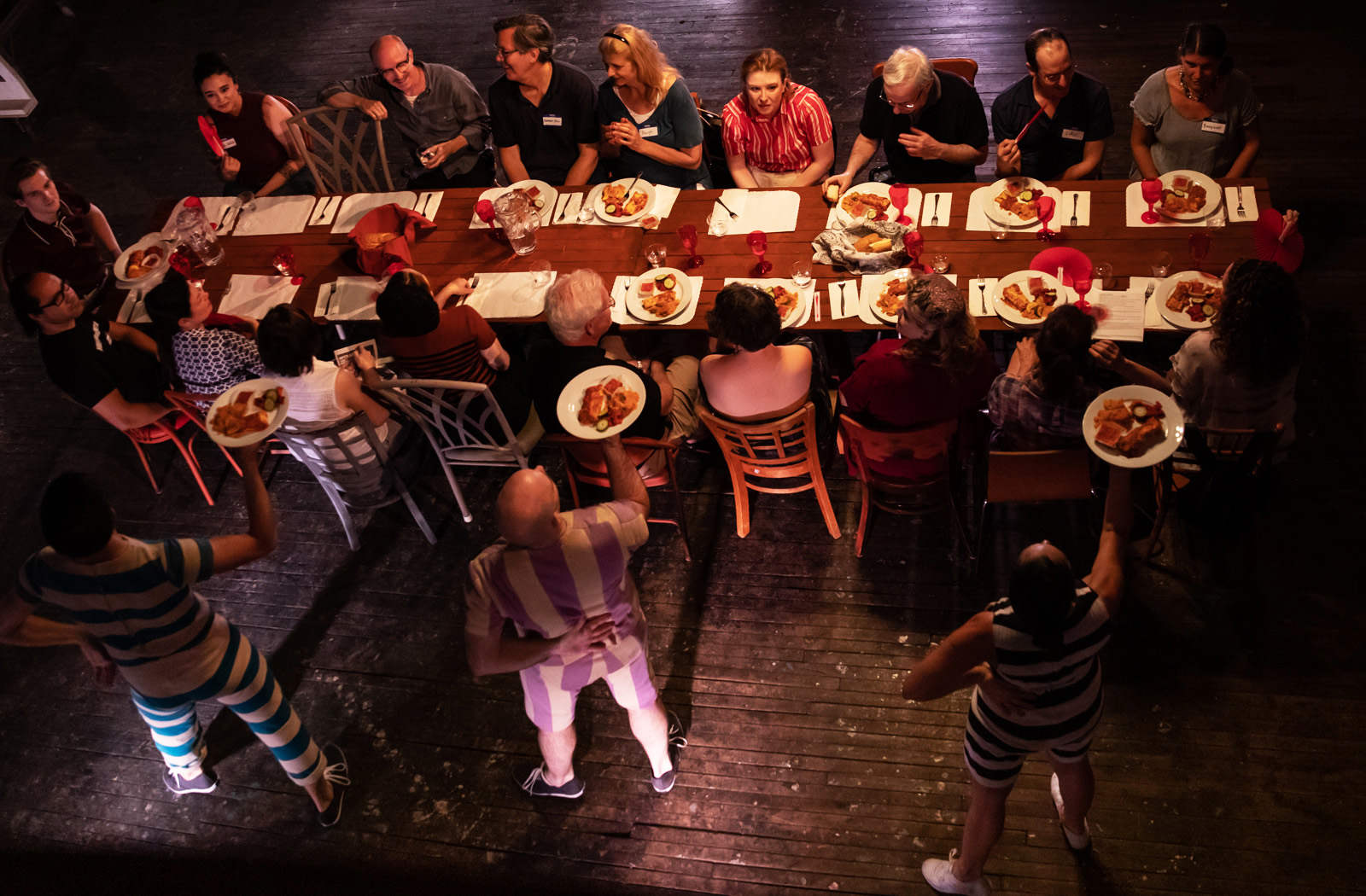 AFTERPARTY: The Rothko Studio 2019 production. The dancer/waiters serve audience memebers dinner at a long table, as seen from above in the mezzanine.