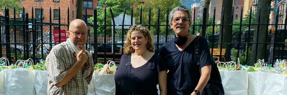 Peculiar Works Project's Artistic Directors Ralph Lewis, Catherine Porter, and Barry Rowell pose with bags of food they helped deliver for Henry Street Settlement Food Pantry during 2020-2021.