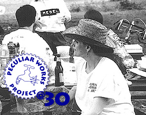 A black and white photo of Catherine Porter at a PWP picnic in 1996 with the logo Peculiar Works Project at 30.